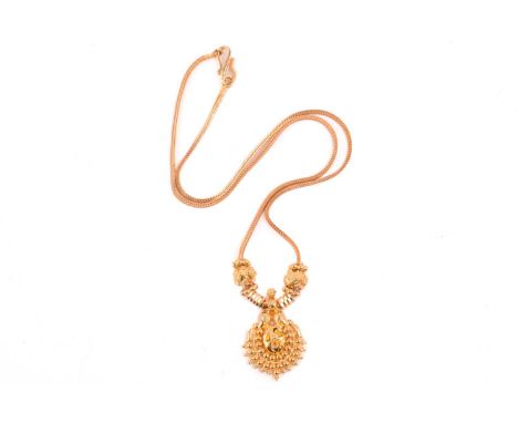 An Indian pendant on chain, composed of a pendant with floral and granulation details, flanked by faceted rondelles, on a fox