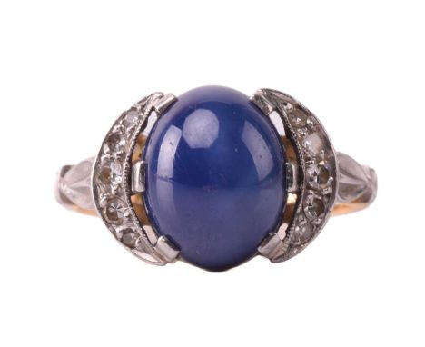 A synthetic star sapphire and diamond dress ring, centrally mounted with a synthetic sapphire cabochon in a claw setting, app