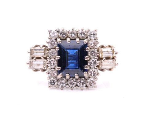 A sapphire and diamond entourage ring, featuring a rectangular step-cut sapphire of deep blue colour, approximately measures 