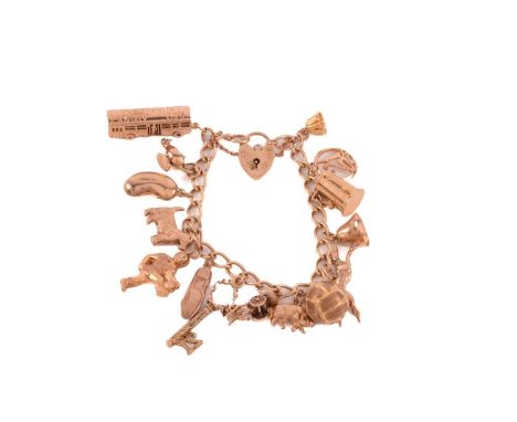 A 9ct yellow gold charm bracelet with a heart-shaped padlock, consisting of a curb chain, suspending with a collection of fif