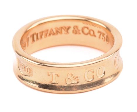 Tiffany &amp; Co. - an 18ct yellow gold ring from the '1837' collection, the 6.1 mm wide concave band etched with the signatu