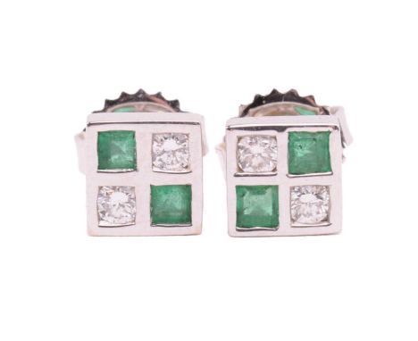 A pair of emerald and diamond stud earrings in 18ct white gold, each comprising two circular-cut diamonds and two square tabl