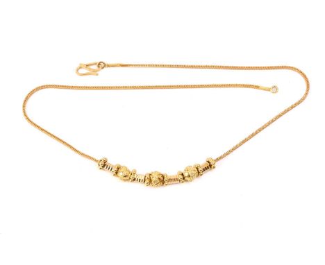 An Indian beaded necklace, composed of beads with granulation details, flanked by faceted rondelles, on a foxtail chain with 