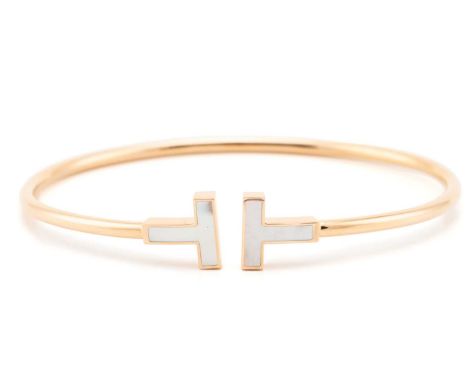 Tiffany & Co. - A Tiffany T wire bracelet with mother-of-pearl terminals, signed, pink metal stamped 'Au750 Italy', internal 