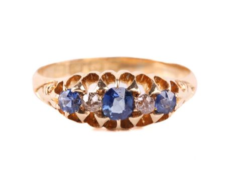 An Edwardian sapphire and diamond five stone half hoop ring, the central sapphire measuring 3.8mm x 3.6mm, the diamonds with 