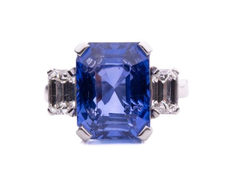 A sapphire and diamond trilogy ring, featuring a large colour-change sapphire in octagonal-cut with an estimated weight of 20