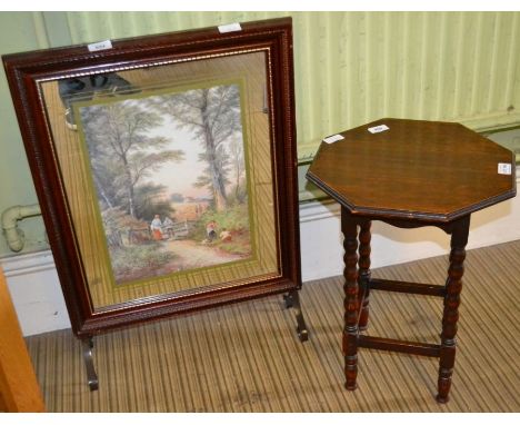 A small oak table together with a firescreen