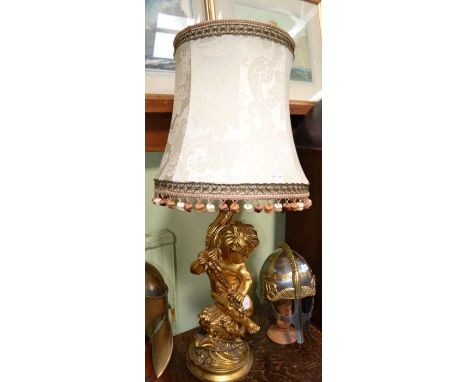 A 20th century gilded composition table lamp, in the form of a cherub supporting a Cornucopia, height to the light fitting, 6