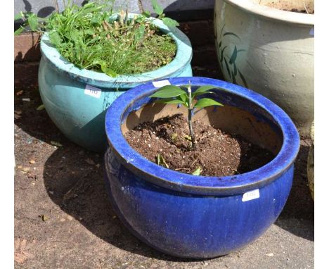 Two squat glazed pottery planters, one light and one dark blue