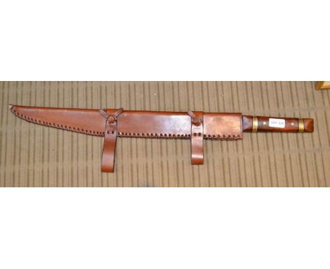 A wood and brass handled short re-enactment sword in leather scabbard