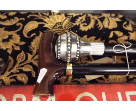 An ebonised walking cane with polished aluminium beaded knop handle together with an adjustable walking stick