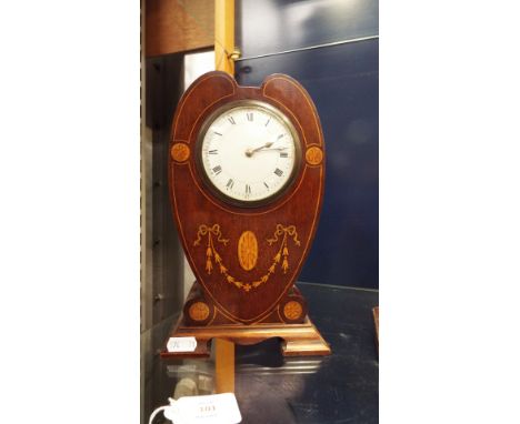 A mahogany and satinwood strung heart shaped balloon clock having shell and swag Art Nouveau decoration, the dial having Roma