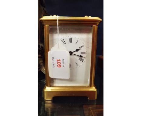 A brass and glass carriage clock, the enamel dial having Roman numerals, in working order with key present