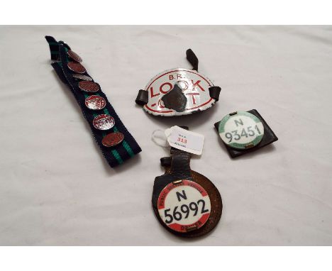 A quantity of bus/travel memorabilia; a conductor and a driver's badge, an enamel 'Look Out' sign and some vintage enamel tra