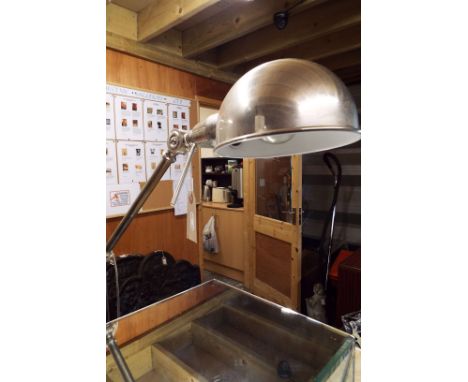 A modern nickel plated industrial style adjustable work lamp