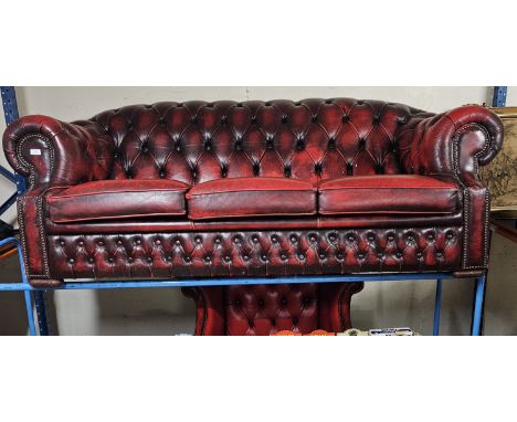 3 PIECE CHESTERFIELD OX BLOOD SUITE COMPRISING CAMEL BACK STYLE COUCH, WING BACK ARMCHAIR AND FOOTSTOOL ALL WITH BUTTON BACK 
