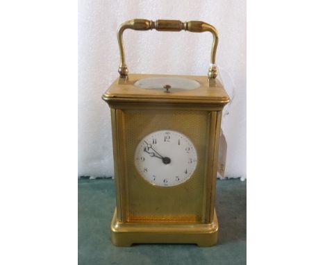 A late 19th/early 20th century French gilt brass carriage clock, the twin barrel gong striking repeating movement within a fi