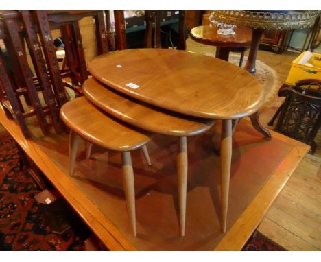 A set of three Pebble ercol nesting tables, each on tripod supports (the largest 64cm x 43cm). Condition Report: Unpainted.Ap