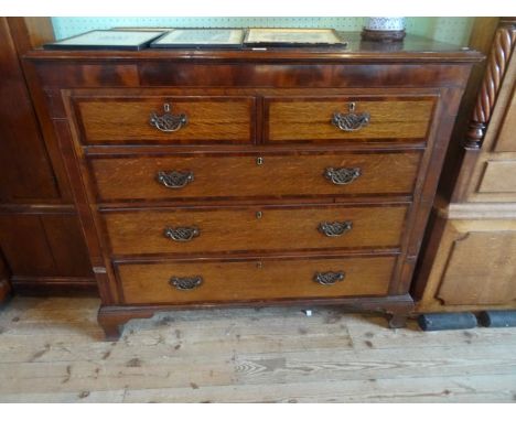 An oak and inlaid chest having two short over three graduated drawers on bracket feet (130cm wide).