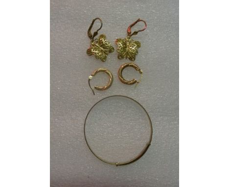 A 9 carat gold child's bangle, together with two pairs of 9 carat gold earrings.