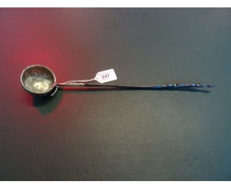 A 19th century horn handled white metal toddy ladle, having chased decoration (35cm).