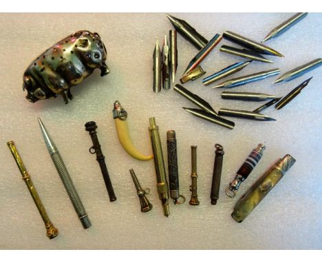 A silver pin cushion modelled as a pig (AF), together with a quantity of yellow metal and white metal propelling pencils and 