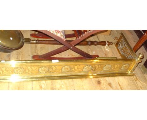 A brass fender, having relief decoration in the aesthetic style (123cm), together with four brass fire tools.