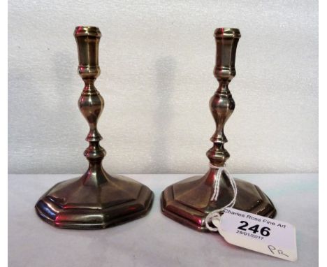 A pair of Queen Anne-style Britannia standard silver candlesticks, the octagonal bases bearing the mark of Thomas Merry, Lond