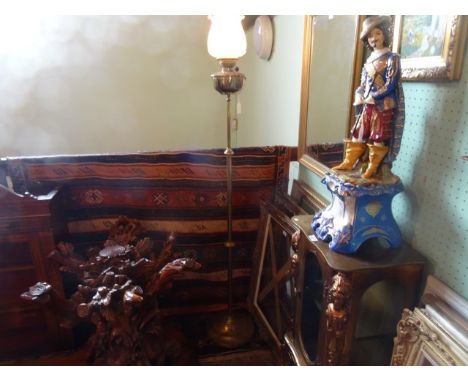 A late Victorian brass standard oil lamp, converted to electricity, having an opaline moulded shade decorated in the aestheti