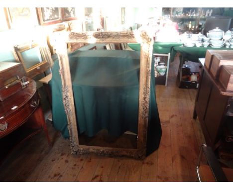 A gilt composite and moulded picture frame (118cm x 77cm).