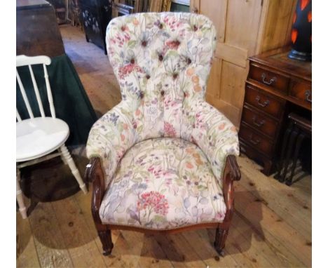 A late Victorian mahogany button back upholstered armchair on front reeded supports (68cm wide).