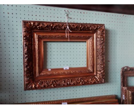A gilt composite picture frame, having profuse moulded decoration (45cm x 57cm).