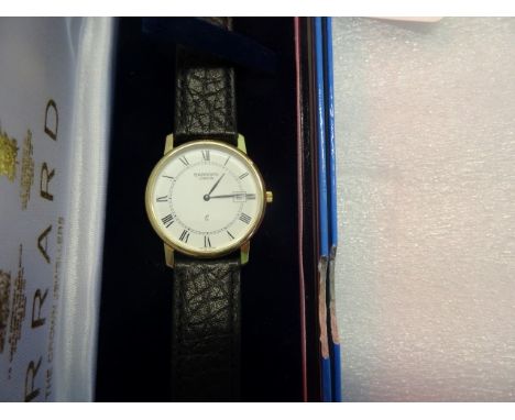 A cased and boxed Garrard and 18 carat gold wristwatch, the enamel dial bearing Roman numerals and with date aperture at 3 o'
