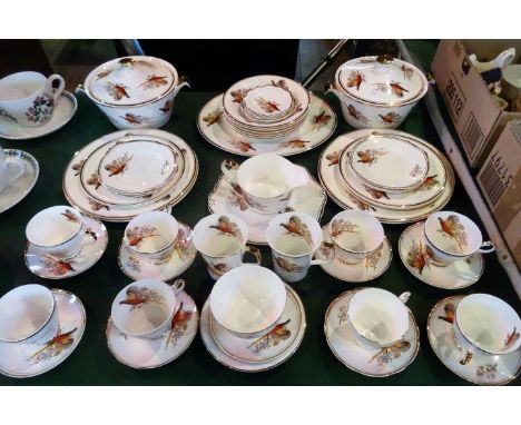 A Sheriden bone china part-dinner service, decorated with pheasants on an ivory and gilt ground, comprising: vegetable tureen