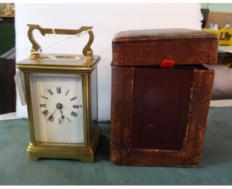 A French gilt brass cased carriage clock, the twin barrel striking gong movement within a five panel bevelled edged glass cas