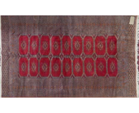 A Bokhara carpet with gull motifs on a red and orange ground contained by geometric borders. 190x127cm 