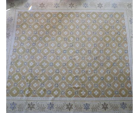 A Persian Ziegler style carpet, floral motifs on a mustard ground, within stylised floral border on a pale yellow ground, 460