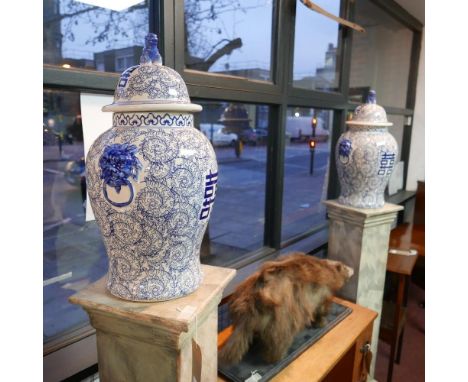 A pair of Chinese blue and white temple jars and covers, with twin lion mask handles, decorated with scrolling foliage, dog o