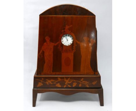 A mahogany and marquetry inlaid watch stand in the form of an arched mantel clock, inlaid with Classical maidens flanking a c