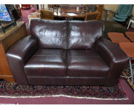 A contemporary two seater faux leather sofa 