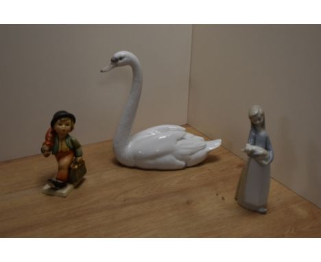 A Lladro porcelain study of a swan, 21.5cm with printed and impressed marks to base, together with a Lladro porcelain figurin