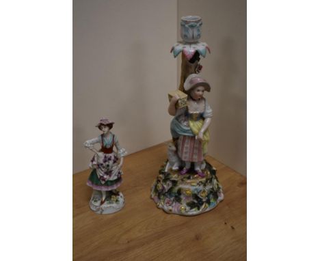 A Sitzendorf porcelain figural candlestick, formed as a young girl stood aside a lamb and tree trunk, the rocaille base encru