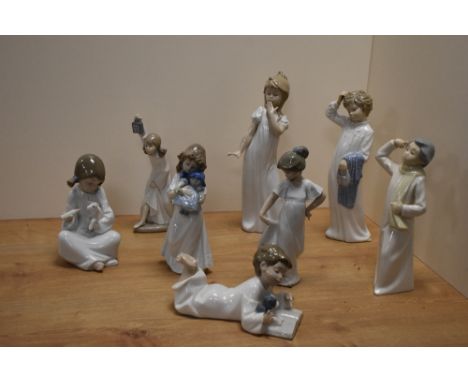 A group of eight Nao by Lladro porcelain figures and figurines, depicting children dressed in nightwear, various poses and si