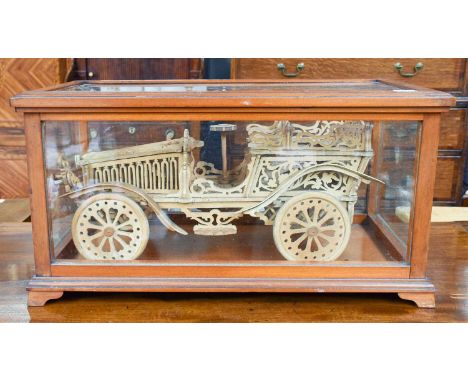 A Wooden Fretwork Model of a Vintage Two-Seater Motor Car,  41cm in length, in glazed mahogany display case a/f