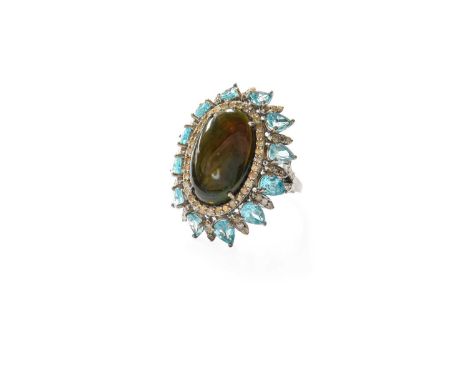 An Opal, Apatite and Diamond Cluster Ring, the oval cabochon opal within a border of round brilliant cut diamonds, to an oute