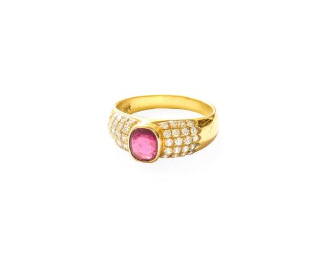 A Ruby and Diamond Ring, the cushion cut ruby in a yellow rubbed over setting, to round brilliant cut diamond set shoulders i