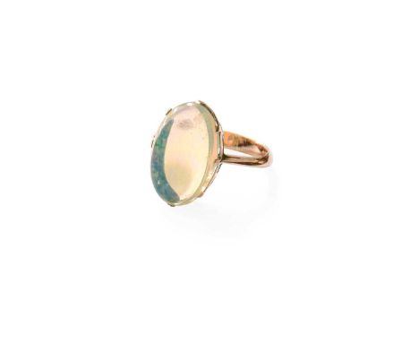 An Opal Ring, the oval cabochon opal in a yellow claw setting, to a tapered shoulder plain polished shank, finger size H1/2Gr