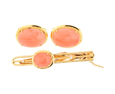 An 18ct gold coral and diamond dress set, comprising tie clip and pair of cufflinks, set with oval cabochon corals, clip 51mm