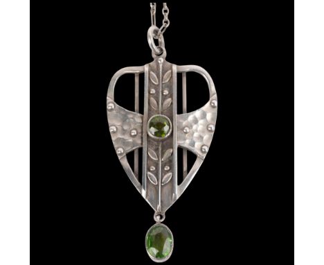 ATTRIBUTED TO LIBERTY & CO - an Arts and Crafts silver peridot Plantagenet openwork pendant necklace, shield form with stylis