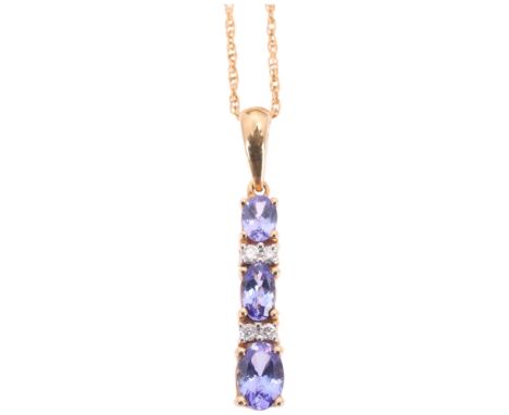 A 9ct gold tanzanite and diamond drop pendant necklace, set with graduated oval mixed-cut tanzanites and modern round brillia